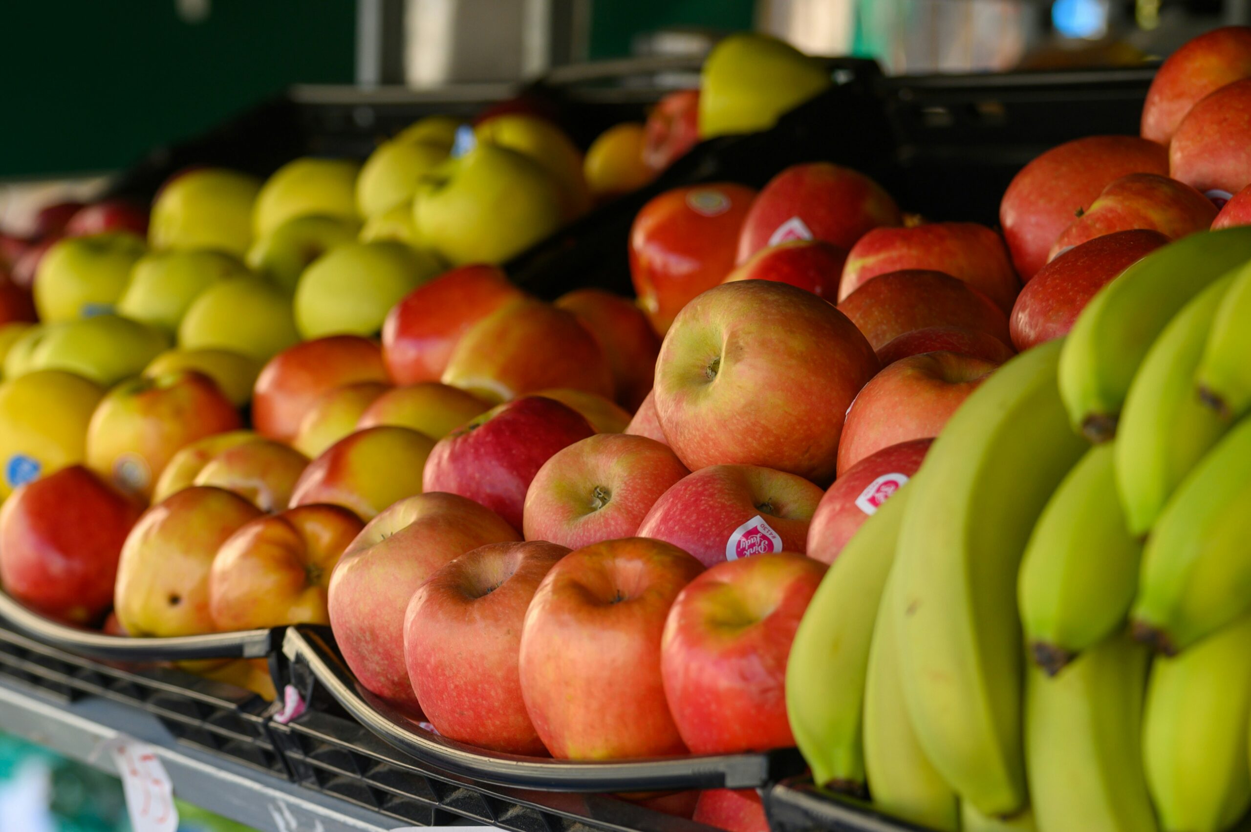 a bunch of apples and bananas are on display